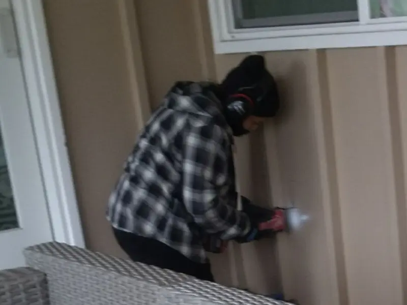 Professional electrician installing an exterior outlet in Benton