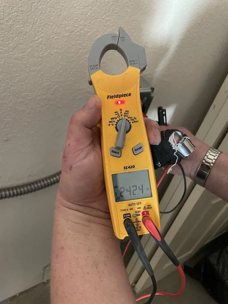 Voltage testing with clamp meter during Ceiling Fan Installation in Benton